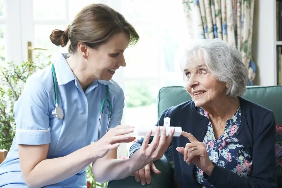 Skilled Nursing in Massachusetts | CareLink Home health nurse reviewing medications with an older woman in her living room during a home visit